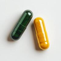Capsules filled with colorful powders on a plain background in a close up view photo