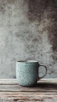 Simple blue mug on rustic wooden surface with textured background photo