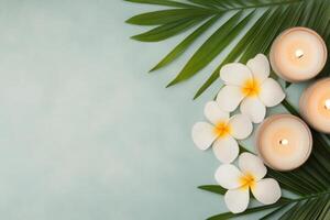 Tranquil spa arrangement with candles and flowers on gentle blue background photo