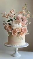 Elegant cake adorned with exquisite floral arrangements in soft pastel colors photo