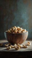 Cashews in a wooden bowl with steam rising in a rustic setting photo