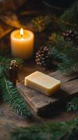 Natural soap and essential oil surrounded by pine and candlelight during winter photo