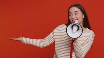 Woman talking with megaphone, proclaiming news, loudly announcing advertisement pointing empty place video