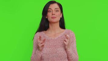 Stylish woman in sweater shouting, raising fists in gesture I did it, celebrating success, winning video