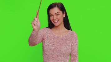 Magician witch young woman gesturing with magic wand making wish come true, casting magician spell video