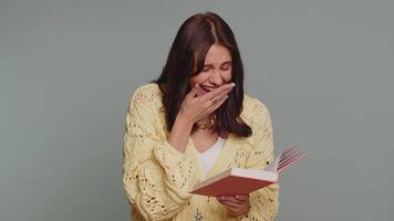Happy woman reading funny interesting fairytale story book, leisure hobby, education, learning video