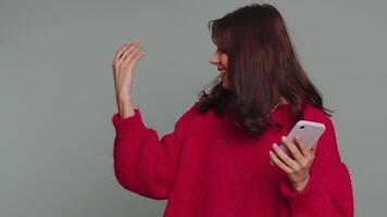 Girl using smartphone pointing empty place, positive feedback recommends social networks application video
