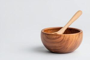 Wooden bowl with spoon on a plain background for culinary presentation photo