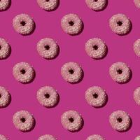 Pattern with pink donuts on the violet background photo