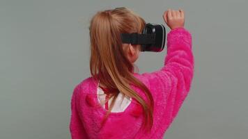 Preteen child girl kid using headset app to play simulation game watching virtual reality 3D video