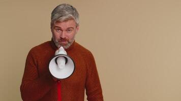 Man talking with megaphone, proclaiming news, loudly announcing advertisement pointing empty place video
