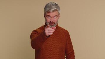 Man pointing to camera and looking with playful happy expression, making choice, showing direction video
