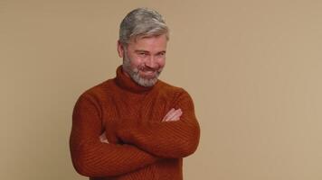 Smiling playful happy middle-aged old man looking at camera with smile, flirting expressing optimism video