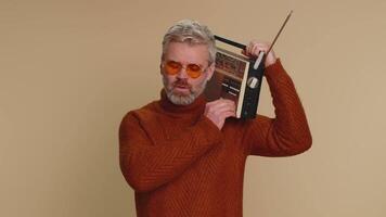 Man using retro tape record player to listen music, disco dancing of favorite track, having fun video