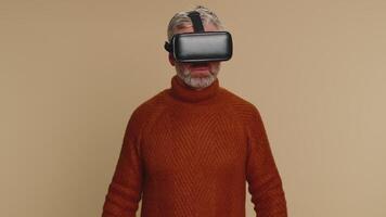 Senior man using virtual reality headset helmet to play simulation game app, watching content video