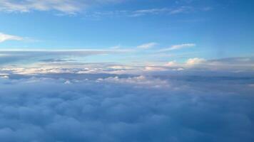 Aerial view of clouds from the airplane window at sunset. Travel and nature concept video
