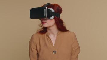 Young woman using virtual reality headset helmet to play simulation game app, watching content video