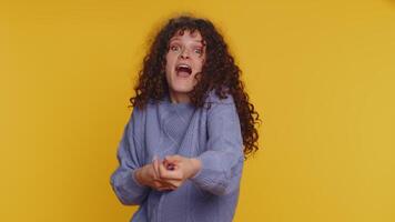 Mime curly haired woman pulling an imaginary unreal invisible rope, puts lot of effort celebrate win video