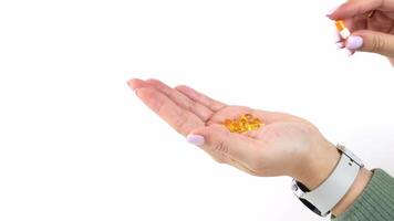 Hand collecting and dispensing golden capsules with precision and care video