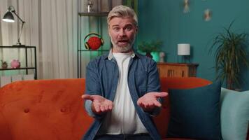 Middle-aged man asking why, what reason of failure demonstrating disbelief irritation by troubles video