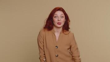 Funny joyful woman making playful silly facial expressions, grimacing, fooling around showing tongue video