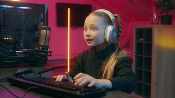 Concentrated little Caucasian girl teenager gamer streamer child kid daughter using computer neon home addiction virtual game playing streaming shaking head no not stop enough gesture failure lost video