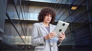 A Professional Woman Skillfully Using a Tablet in a CuttingEdge Urban Setting Today video