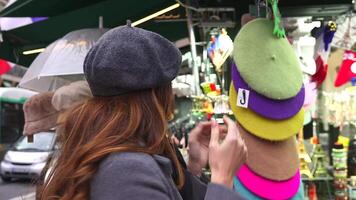 Smiling Tourist Browsing Hats at Paris Market with French Souvenirs video