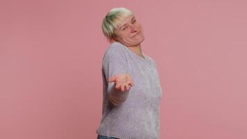 Woman showing a little bit gesture with sceptic smile, showing minimum sign measuring small size video