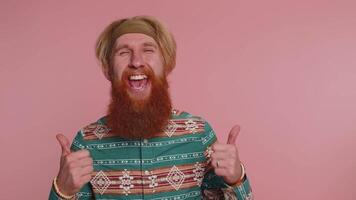 Cheerful hippie man greatly approves your suggestion, shaking head approvely like good nice proposal video