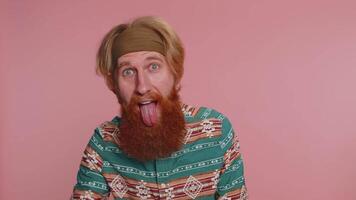 Funny joyful man making playful silly facial expressions, grimacing, fooling around showing tongue video