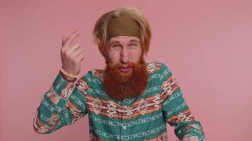 Hippie redhead man pointing at camera and showing stupid gesture, blaming some idiot for insane plan video