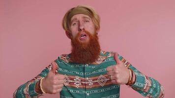 Tourist stylish man in pattern shirt showing thumbs up and nodding in approval, successful good work video