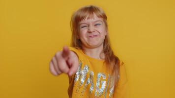 Amused child girl kid pointing finger to camera, laughing out loud funny ridiculous joke reaction video