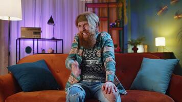 Bearded hippie man asking why, what reason of failure demonstrating disbelief irritation by troubles video