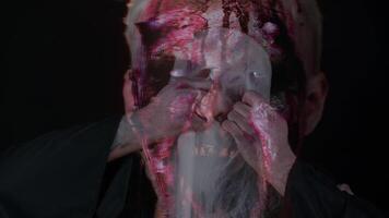 Scary wounded zombie undead guy making faces, hiding through spider web, smiles terribly, scares video