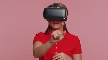 Young woman using virtual reality headset helmet to play simulation game app, watching content video