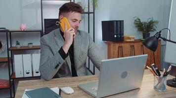 Business man in suit working, having mobile phone talk at office workplace using messenger chat apps video