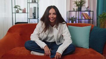 Young smiling woman pointing to camera, choosing lucky winner, indicating, inviting, approve at home video