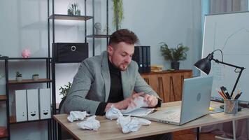 Angry furious man working at home office throwing crumpled paper, having nervous breakdown at work video