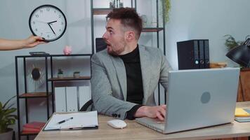 Business man working on laptop at office with anxiety checking time on clock being late, deadline video