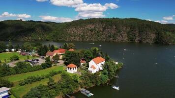 Aerial orbiting view of reservoir Slapy and Zivohost port in Czechia in August 2024 video