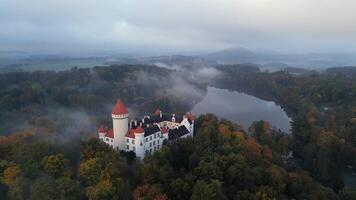 Aerial view of foggy castle Konopiste and pond in Czechia in October 2024 video