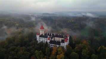 Aerial orbiting view of foggy castle Konopiste in Czechia in October 2024 video