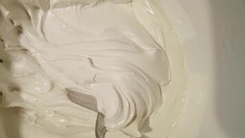 Smooth swirling motion of thick cream batters in slow stirring action. video