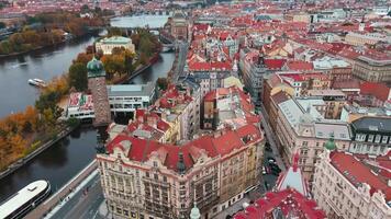 Aerial view of Prague cityscape with historical buildings and colorful autumn trees on island on Vltava river. Architecture of Praha, Czech Republic video