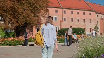 Woman walking in Wawel Castle in Krakow. Female tourist enjoying medieval royal architecture. Touristic landmark in Poland video