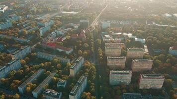 Aerial view of Wroclaw, Poland. Bird eye view of cityscape with colorful autumn trees and red roofs. City neighborhood with residential buildings and many green spaces in European city video