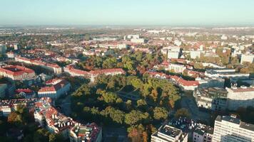 Aerial view of Wroclaw, Poland. Bird eye view of cityscape with colorful autumn trees and red roofs. City neighborhood with residential buildings and many green spaces in European city video