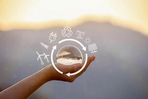 net zero and carbon neutral concept. Net zero text in crystal ball on human hand photo
